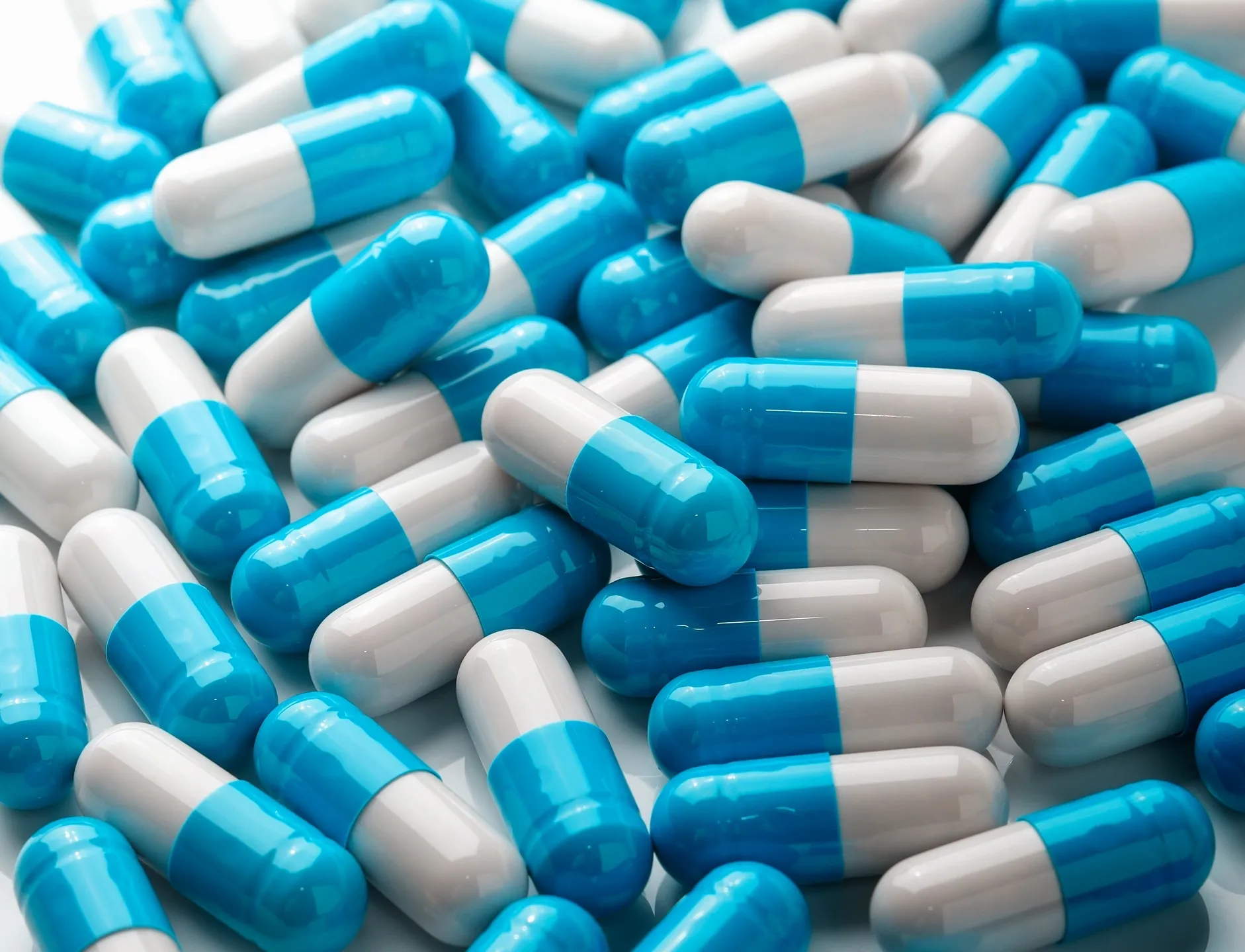 Assorted blue-white medication capsules